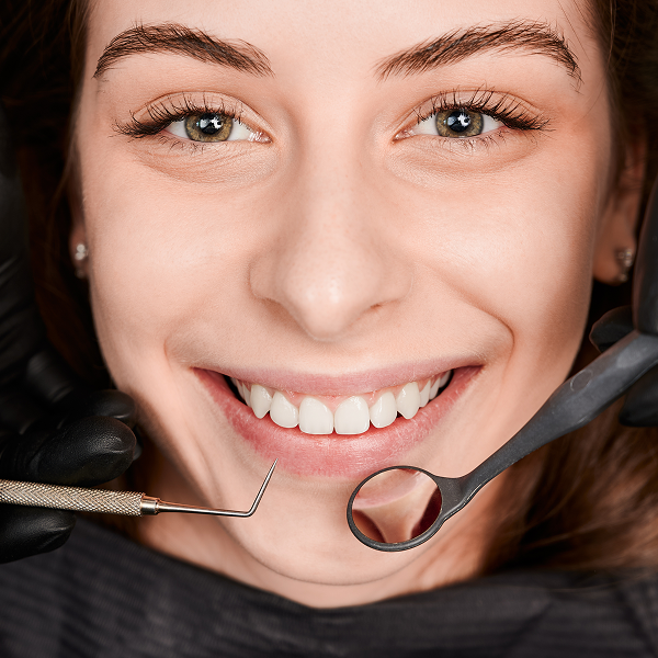 Patient with a bright, confident smile after treatment at Sunset Dentistry